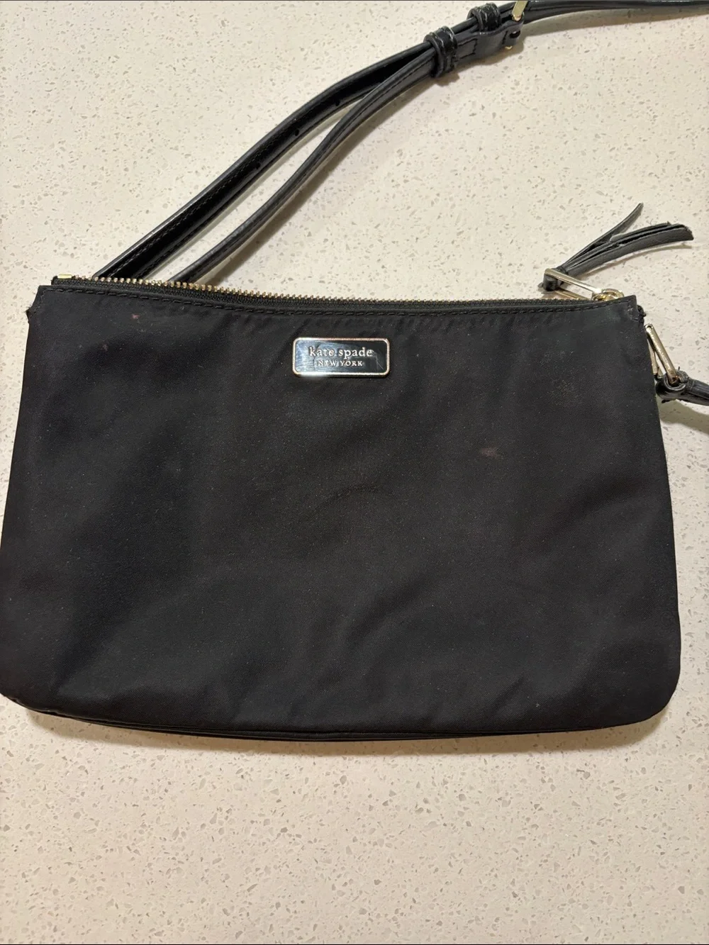 kate spade black crossbody pouch with gold-tone logo